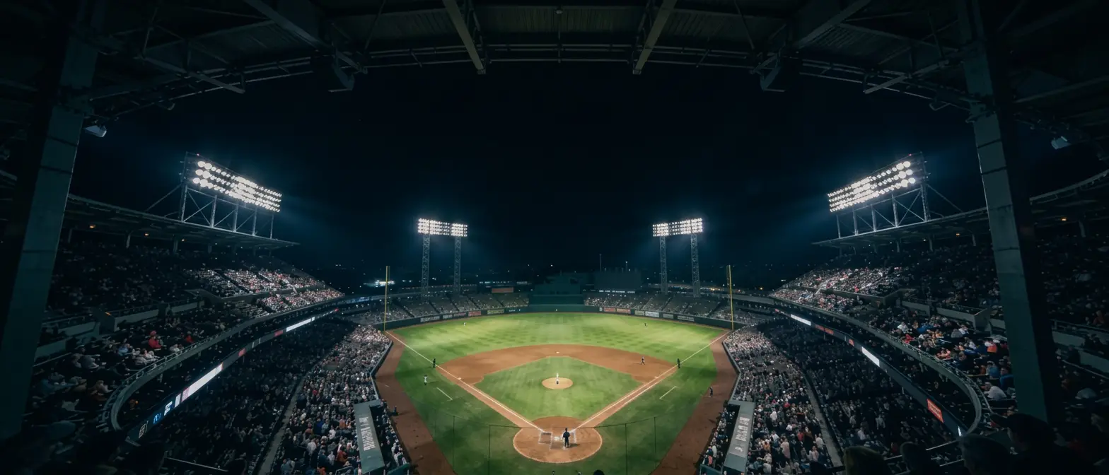 Baseball stadium under the lights at night, seen from behind home plate